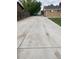 An expansive, long concrete driveway that leads to the garage at 8220 E 104Th Way, Henderson, CO 80640