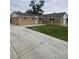 An exterior shot of the home highlighting the long driveway and lawn at 8220 E 104Th Way, Henderson, CO 80640