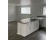 Kitchen island with grey countertops and sink, modern cabinets and stainless steel appliances at 8220 E 104Th Way, Henderson, CO 80640