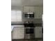 Modern kitchen featuring stainless steel appliances, white cabinets, and countertops at 8220 E 104Th Way, Henderson, CO 80640