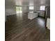 Kitchen features an island with sink, stainless steel appliances, and new wood flooring at 8220 E 104Th Way, Henderson, CO 80640