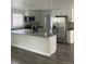 Bright open kitchen with an island, new stainless appliances, and ample counter space at 8220 E 104Th Way, Henderson, CO 80640