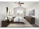 Staged bedroom features bed, furniture, decor, vaulted ceiling, neutral carpet, and a window at 11972 W Long Cir # 204, Littleton, CO 80127