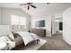 Staged bedroom features bed, furniture, decor, vaulted ceiling, neutral carpet, and an entry door at 11972 W Long Cir # 204, Littleton, CO 80127