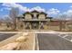 Community clubhouse with double door entry, benches for seating, and well-maintained landscaping at 11972 W Long Cir # 204, Littleton, CO 80127