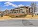 Community clubhouse features a stone chimney, covered patio, and attractive landscaping at 11972 W Long Cir # 204, Littleton, CO 80127