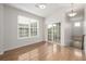 Upstairs dining area with wood floors, large window and sliding glass doors leading to the balcony at 11972 W Long Cir # 204, Littleton, CO 80127