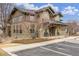 The community clubhouse shows detailed architectural design and ample parking space at 11972 W Long Cir # 204, Littleton, CO 80127