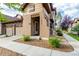 Charming front exterior of home features a two car garage, well maintained landscaping, and clear street numbers at 11972 W Long Cir # 204, Littleton, CO 80127