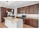The spacious kitchen features stainless appliances and stone countertops at 11972 W Long Cir # 204, Littleton, CO 80127