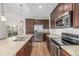 Well-equipped kitchen with modern stainless steel appliances and an island at 11972 W Long Cir # 204, Littleton, CO 80127