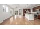 Bright, open living room features hardwood floors and seamless flow into the kitchen at 11972 W Long Cir # 204, Littleton, CO 80127