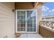 A private patio features a sliding glass door entry and a view of the community's exterior at 11972 W Long Cir # 204, Littleton, CO 80127