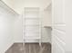 A spacious walk-in closet with ample shelving and rod space for optimal organization at 11972 W Long Cir # 204, Littleton, CO 80127