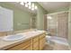 Stylish bathroom featuring a glass shower enclosure and double sink vanity with light fixtures at 12793 Leyden St # D, Thornton, CO 80602