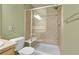 Bathroom featuring a shower with glass door, showerhead, and tile surround at 12793 Leyden St # D, Thornton, CO 80602