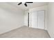 Bright bedroom with neutral carpet, a ceiling fan, and large closet space at 12793 Leyden St # D, Thornton, CO 80602