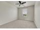 Neutral bedroom featuring a large window with blinds and ceiling fan at 12793 Leyden St # D, Thornton, CO 80602