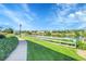 Beautiful community lake view with a path, green space, and a clear blue sky at 12793 Leyden St # D, Thornton, CO 80602