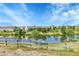 Scenic community lake view with trees, playground, and reflections of homes at 12793 Leyden St # D, Thornton, CO 80602