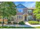 Attractive home with stone accents, a blue gable, and a neatly landscaped front yard at 12793 Leyden St # D, Thornton, CO 80602