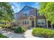 Beautiful townhouse featuring stone accents, a well-maintained lawn, and inviting curb appeal on a sunny day at 12793 Leyden St # D, Thornton, CO 80602