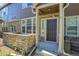 Charming front entrance with stone accents, covered porch, and well-manicured landscaping at 12793 Leyden St # D, Thornton, CO 80602