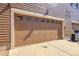Attached two-car garage with decorative window inserts and a concrete driveway at 12793 Leyden St # D, Thornton, CO 80602