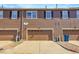 Home exterior featuring garage doors, wood siding, and well-maintained landscaping at 12793 Leyden St # D, Thornton, CO 80602