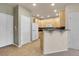Open kitchen featuring light wood cabinets, white appliances, and a breakfast bar for casual dining at 12793 Leyden St # D, Thornton, CO 80602