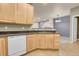 Corner view of the kitchen with countertops, dishwasher, and adjacent living space at 12793 Leyden St # D, Thornton, CO 80602