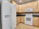 Kitchen featuring modern white appliances and light wood cabinets at 12793 Leyden St # D, Thornton, CO 80602