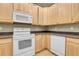 Bright kitchen featuring ample counter space and modern white appliances at 12793 Leyden St # D, Thornton, CO 80602