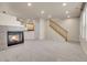 Inviting living room featuring a fireplace, carpeted floors, and a staircase leading to the upper level at 12793 Leyden St # D, Thornton, CO 80602