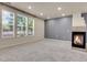 Bright living room boasting large windows, neutral carpet, a gray accent wall, and a cozy fireplace at 12793 Leyden St # D, Thornton, CO 80602
