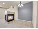 Comfortable living space with a fireplace, neutral carpet, recessed lighting, and a modern accent wall at 12793 Leyden St # D, Thornton, CO 80602