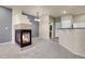 Open-concept living area with a fireplace, connecting to the kitchen with bar seating and a glimpse of the bathroom at 12793 Leyden St # D, Thornton, CO 80602
