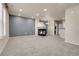 Spacious living room featuring a modern fireplace, neutral carpet, recessed lighting, and a contemporary color scheme at 12793 Leyden St # D, Thornton, CO 80602