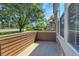 Private patio area featuring wood-look siding and stone trim on the exterior at 12793 Leyden St # D, Thornton, CO 80602
