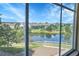 Scenic view of a pond and neighborhood from a window, showcasing lush greenery and a serene environment at 12793 Leyden St # D, Thornton, CO 80602
