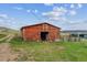 Red barn featuring a large doorway, offering ample space and rural charm at 541 Yucca Hills Rd, Castle Rock, CO 80109