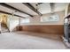 Basement Gathering room featuring a stone fireplace, wood-beam ceiling, and natural light at 541 Yucca Hills Rd, Castle Rock, CO 80109