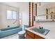 Unique bathroom featuring a blue tub and commode paired with an intricately-carved mirror at 541 Yucca Hills Rd, Castle Rock, CO 80109