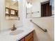 Bright bathroom featuring a marbled countertop, wooden vanity, and mirrored medicine cabinet at 541 Yucca Hills Rd, Castle Rock, CO 80109