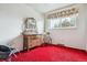 Quaint bedroom showcasing an antique dresser with mirror and traditional rocking chair at 541 Yucca Hills Rd, Castle Rock, CO 80109
