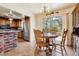 Cozy dining area featuring rustic wood chairs, a round table, and sliding glass doors opening to the backyard at 541 Yucca Hills Rd, Castle Rock, CO 80109