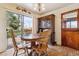 Inviting dining area with a round wood table set, complemented by an antique cabinet and backyard access at 541 Yucca Hills Rd, Castle Rock, CO 80109