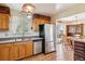 Functional kitchen featuring stainless steel appliances, wood cabinets, and direct access to the dining area and backyard at 541 Yucca Hills Rd, Castle Rock, CO 80109