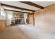 Spacious living room featuring a floor-to-ceiling stone fireplace and wood beam ceiling at 541 Yucca Hills Rd, Castle Rock, CO 80109