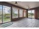 Bright sunroom with large windows, tile floor, and sliding glass doors, providing serene views of the surrounding greenery at 541 Yucca Hills Rd, Castle Rock, CO 80109